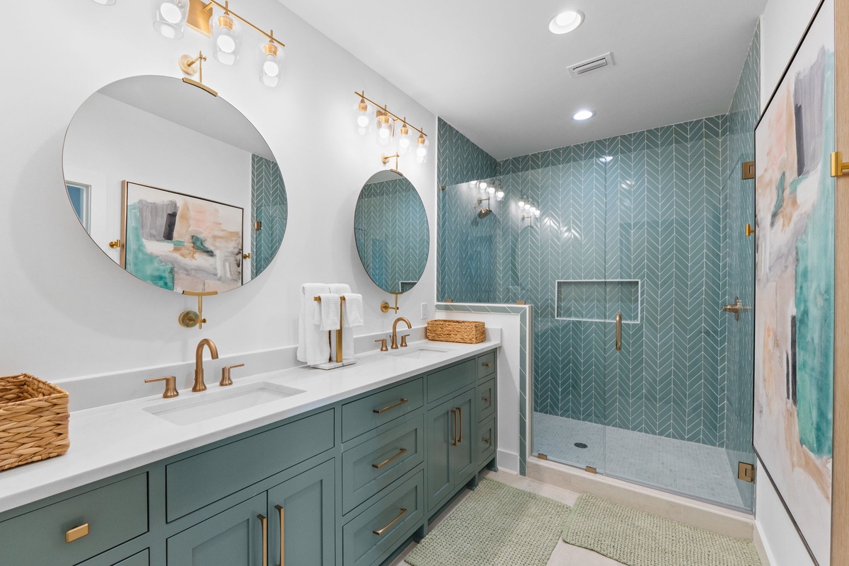 Refresh in your beautifully designed bathroom with dual vanities and a stunning tiled walk-in shower.