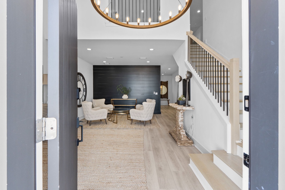 Step into your elegant retreat where soaring ceilings and a stunning circular chandelier create the perfect welcome home atmosphere.