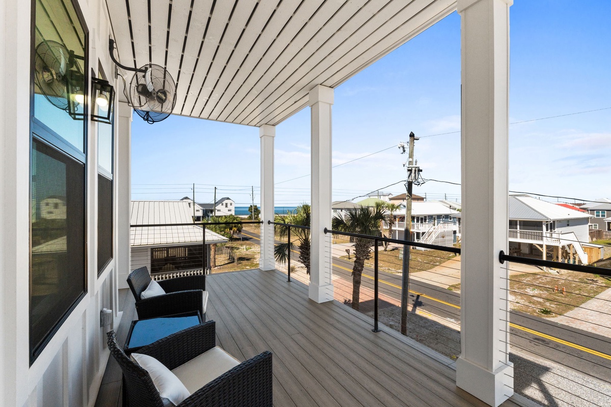 Relax on your covered deck with ocean glimpses, comfortable seating, and coastal breezes.