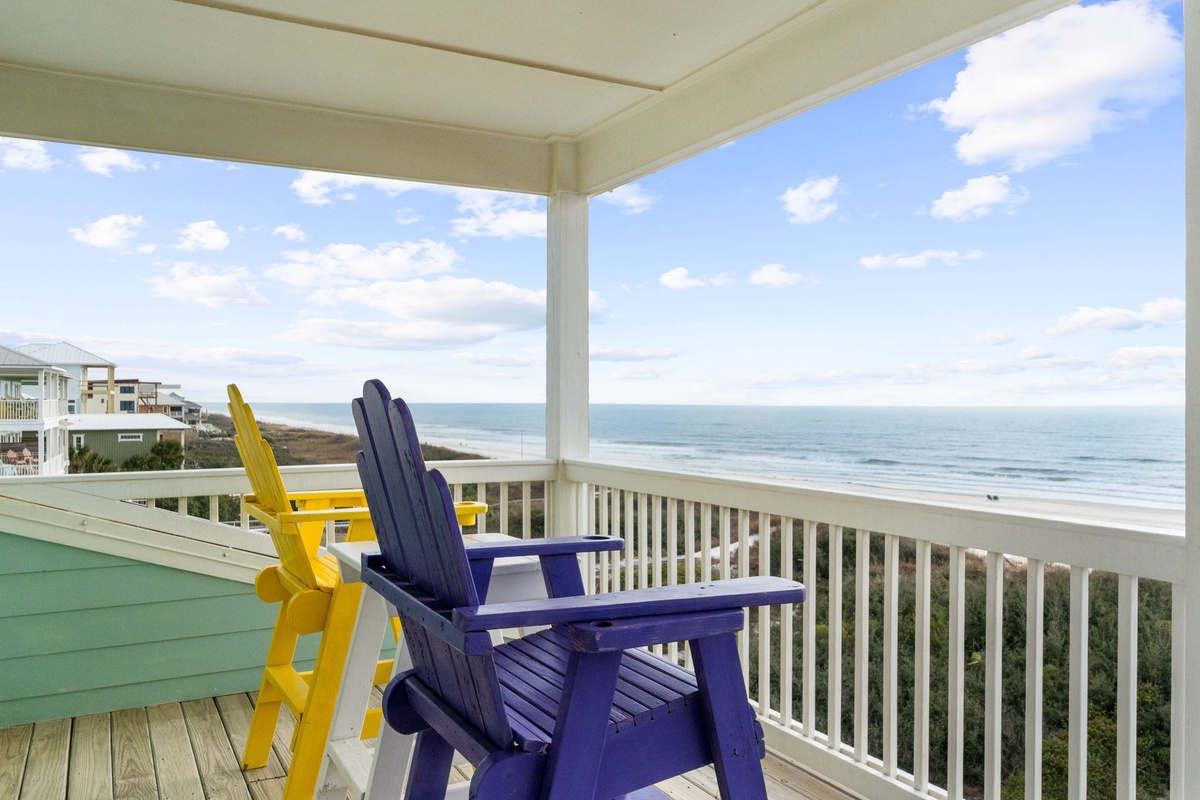 Sink into colorful Adirondack chairs on your private deck and watch endless ocean waves roll in while salty breezes refresh you.