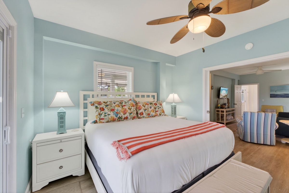Drift off in your coastal-inspired bedroom with soothing blue walls, tropical fan breezes, and colorful florals welcoming sweet dreams.