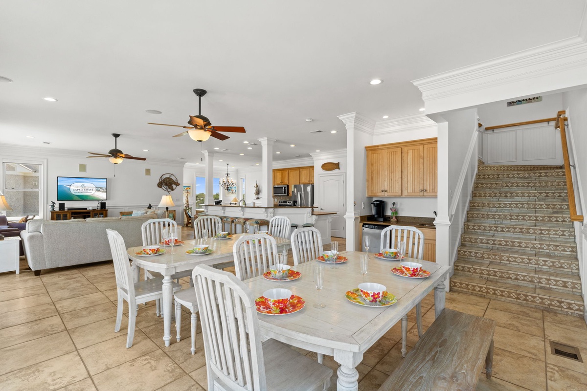 Gather with your group around this spacious dining table, ready for memorable meals in a bright open-concept space with coastal charm and modern comforts.