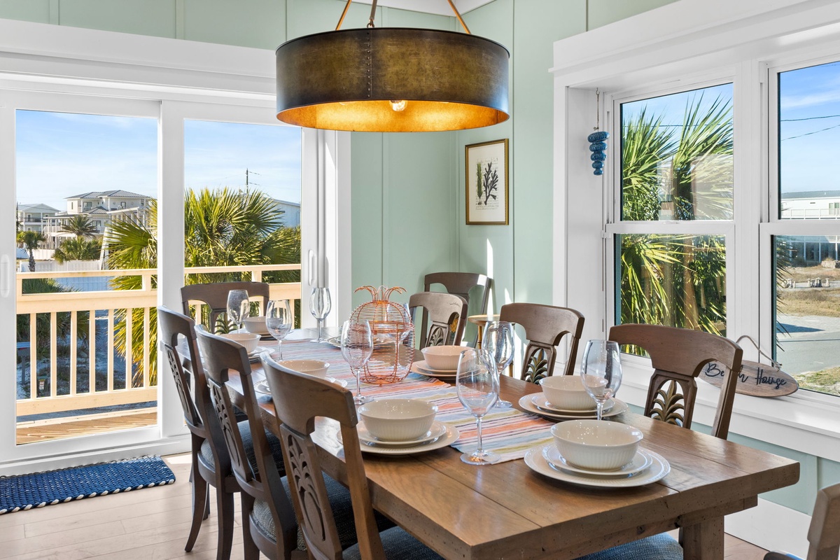 Gather around your elegant dining table where coastal breezes flow through open windows and palm trees frame your beachside meals.