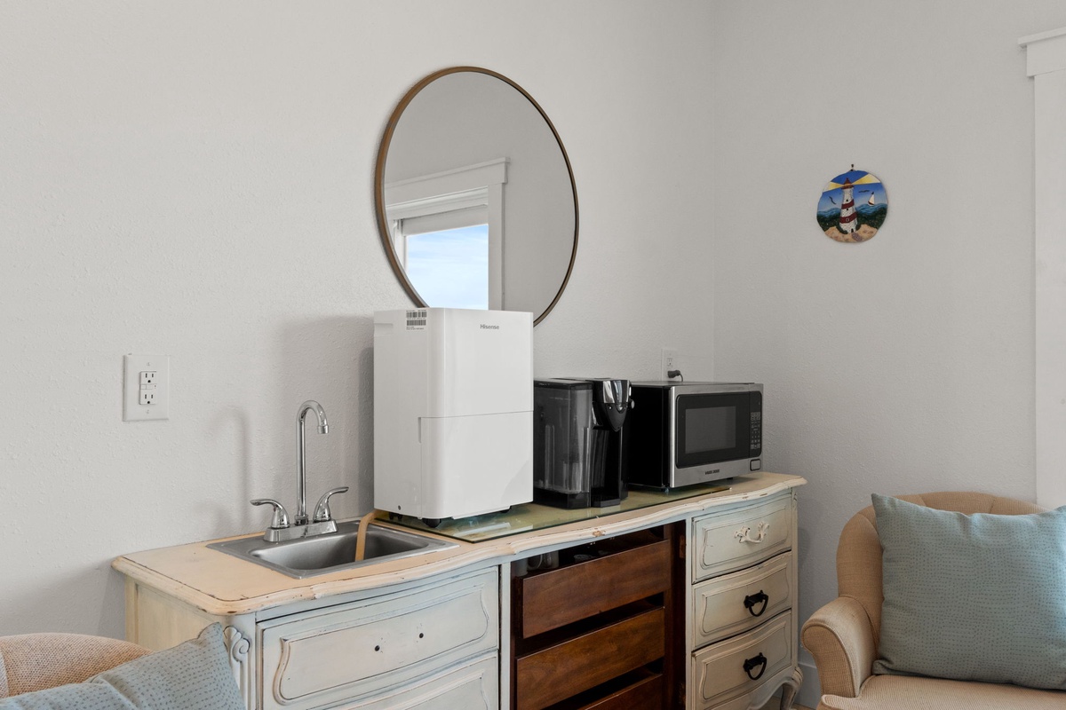 Your cozy kitchenette features a sink, coffee maker, and microwave—everything you need for quick bites and morning coffee in your private space.