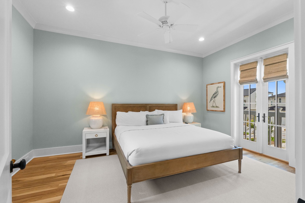 Drift off in this peaceful bedroom with soothing colors, crisp linens, and natural light streaming through your balcony doors.