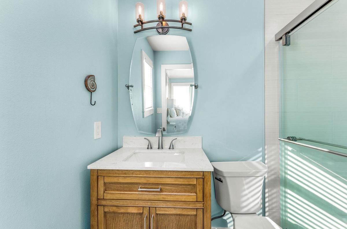 Step into your serene spa-like bathroom where calming sea salt walls and elegant fixtures create the perfect retreat for refreshing mornings.