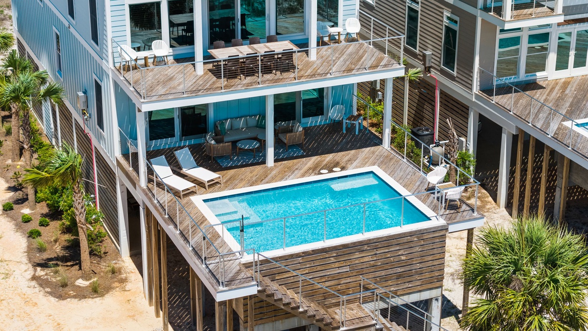 Elevated beachside deck with private pool, sun loungers, and coastal palms—perfect for soaking up sun and sea breezes in your own secluded retreat.
