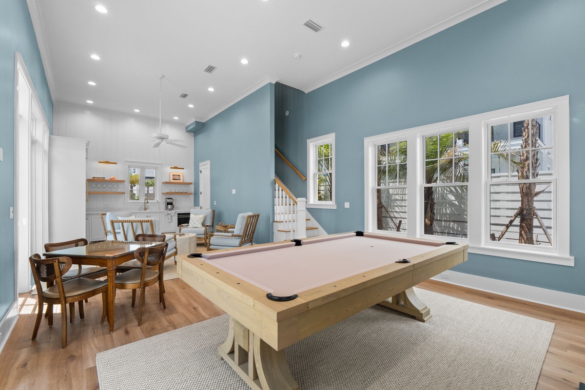 Gather for friendly games at the billiards table, share meals at the dining set, and enjoy the open flow connecting your living spaces under soaring ceilings.