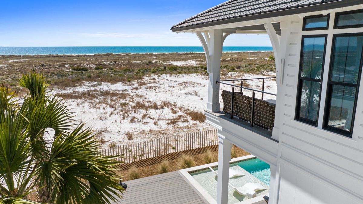 Modern beachfront property with stunning ocean views across pristine dunes and turquoise waters.