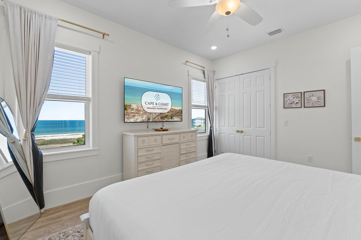 Wake to breathtaking ocean views from your serene bedroom window, complete with crisp linens and modern amenities for ultimate comfort.