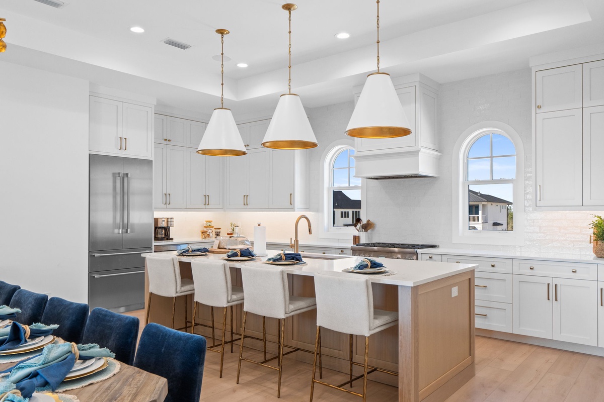 Cook memorable meals in your stunning gourmet kitchen, featuring elegant pendant lighting and premium appliances.