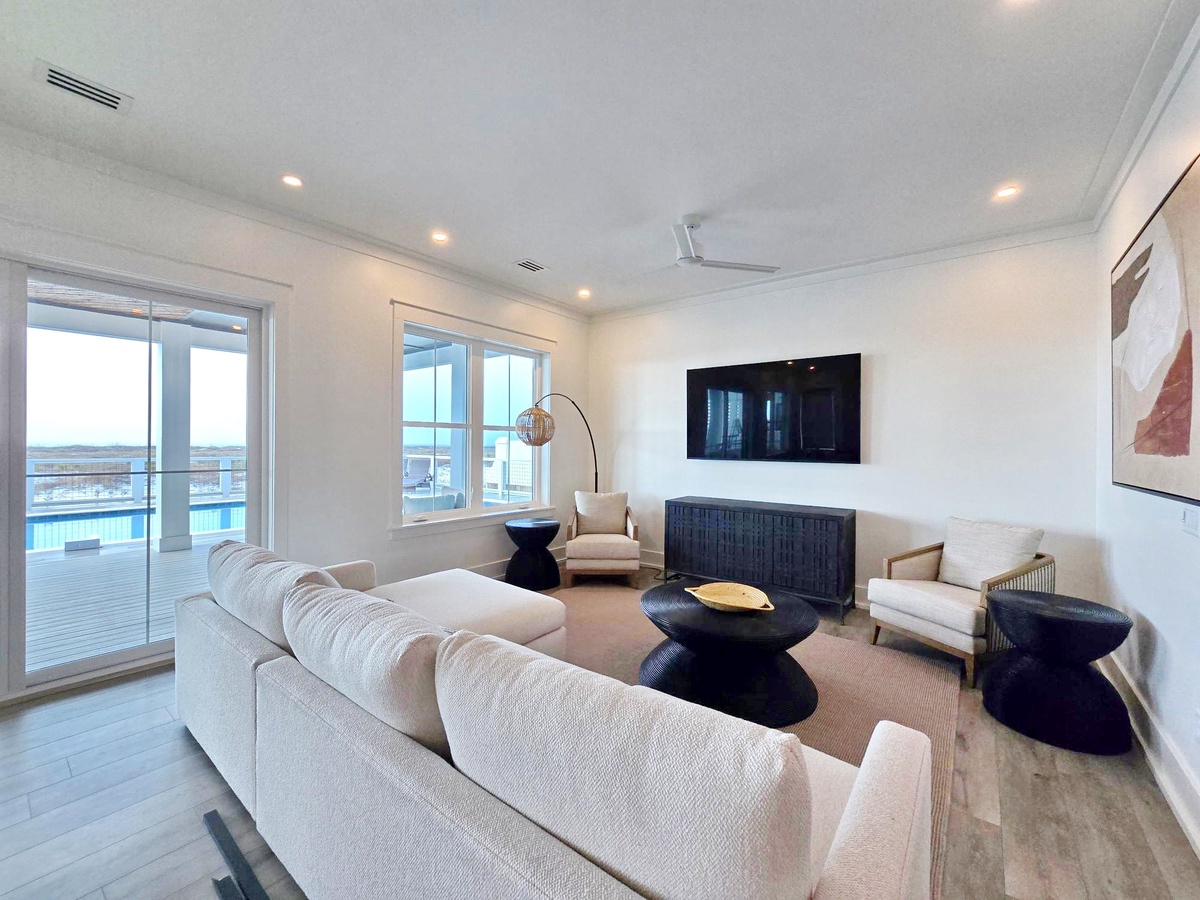 Unwind in your stylish living room with sleek furnishings and expansive windows revealing stunning water views.