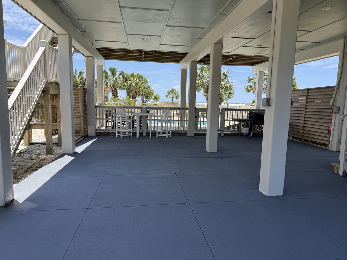 A covered outdoor space with ocean views, perfect for relaxing under the shade while staying close to the beach and enjoying the coastal breeze.