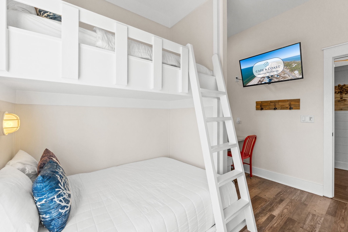 Your cozy bunk room offers space-saving comfort with crisp linens, entertainment, and coastal charm perfect for family adventures.