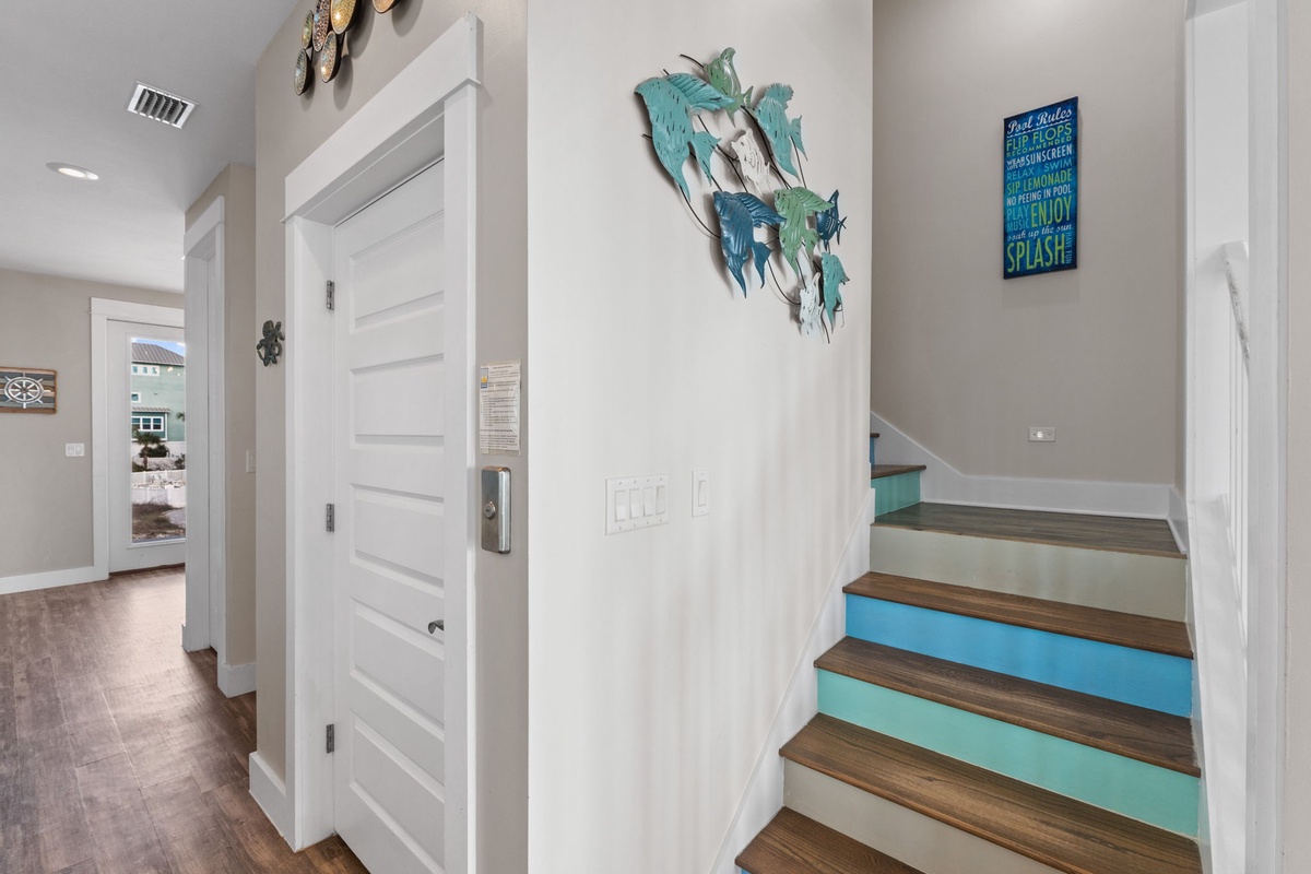 Your beachside retreat welcomes you with coastal charm and playful touches throughout this bright, modern entryway.