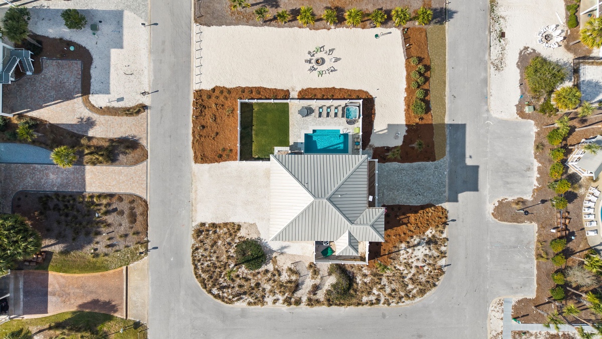 Stunning aerial view showcases this modern villa's complete layout with private pool and landscaped grounds in an exclusive neighborhood setting.