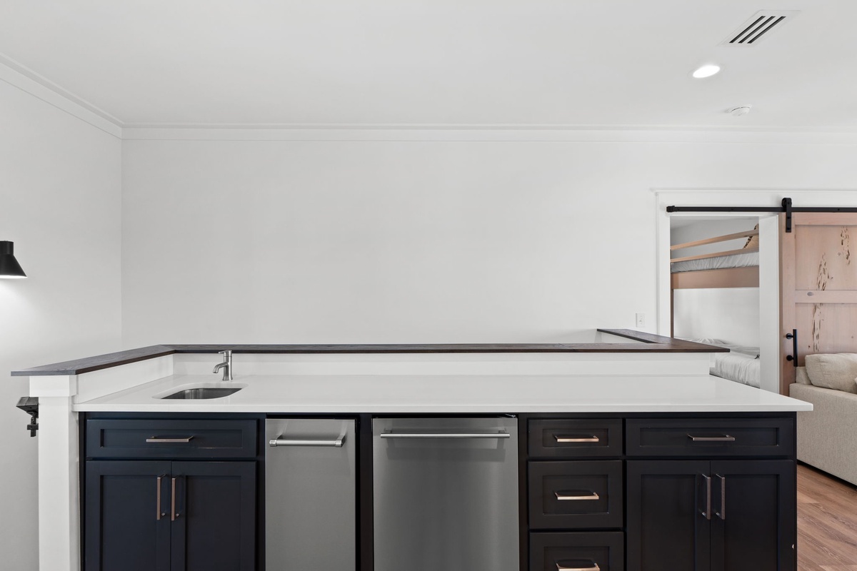 Your sleek kitchen island features modern appliances and ample counter space for preparing meals together.