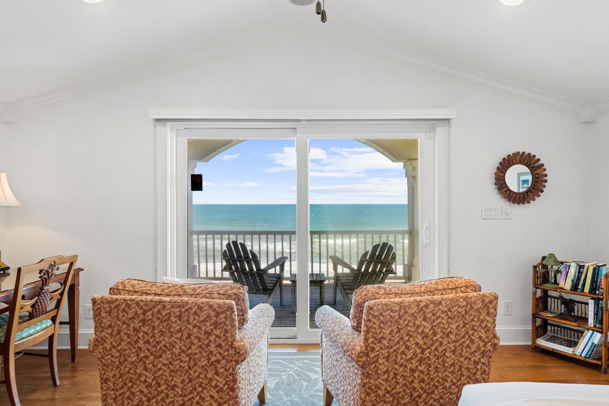 Relax in your bright living space with sliding doors that open to a private balcony, where you can gaze at stunning turquoise waters and soft sand just steps away.