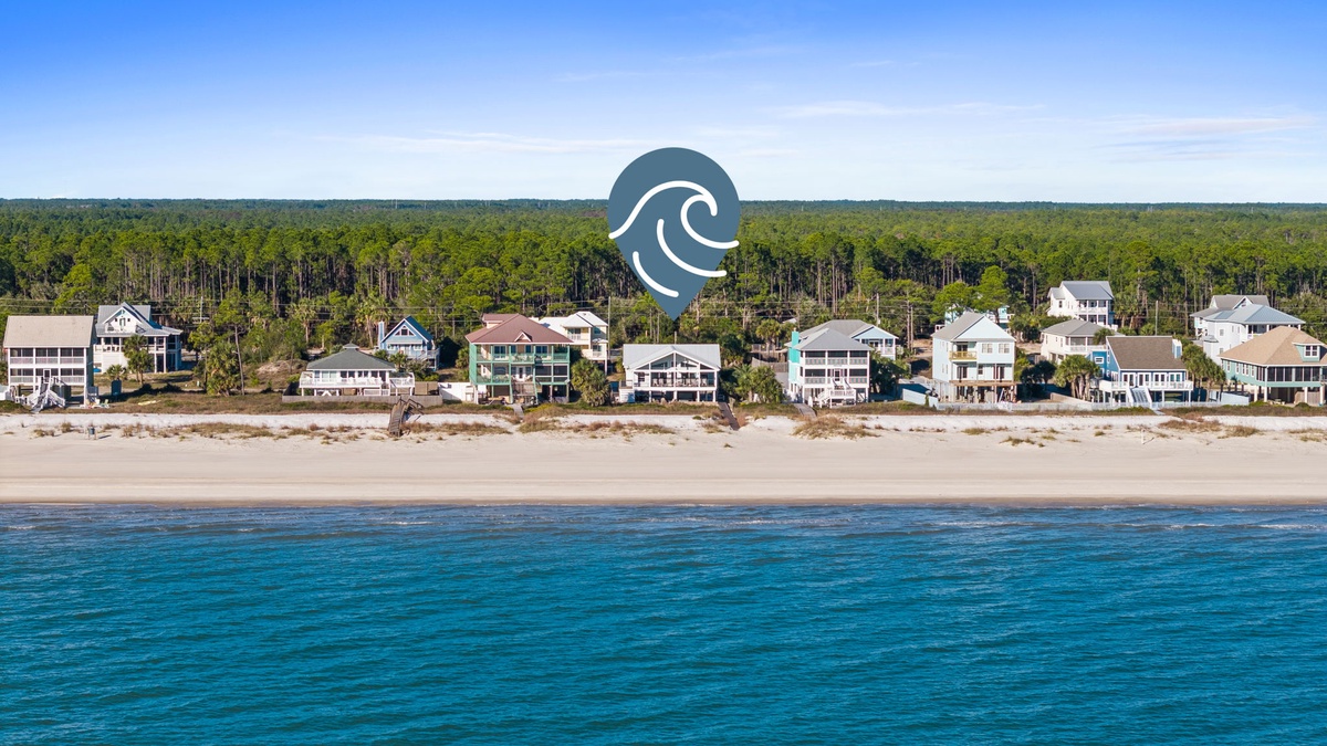 Pristine beachfront community with vacation homes nestled between emerald forests and crystal-clear waters along miles of sandy coastline.
