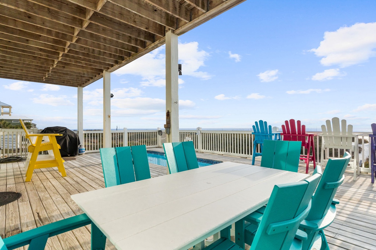 Gather around this spacious dining table while ocean breezes flow through your covered deck, creating the perfect setting for memorable meals.