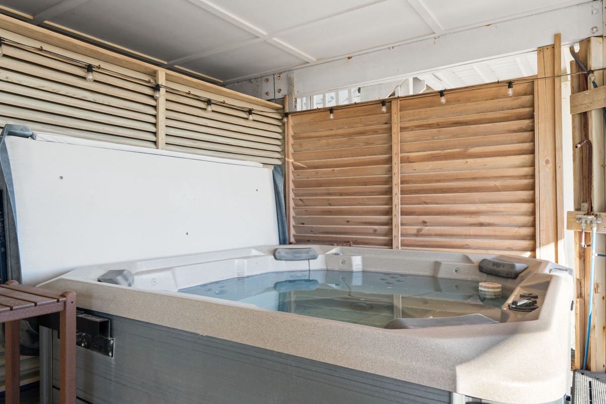 Soak your worries away in your private hot tub, surrounded by natural wood screens for ultimate relaxation and privacy.