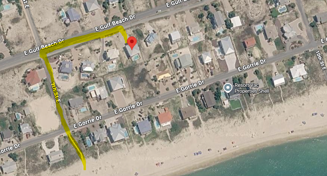 Aerial view shows your beachfront vacation rental location near the pristine Gulf coastline and residential neighborhood.