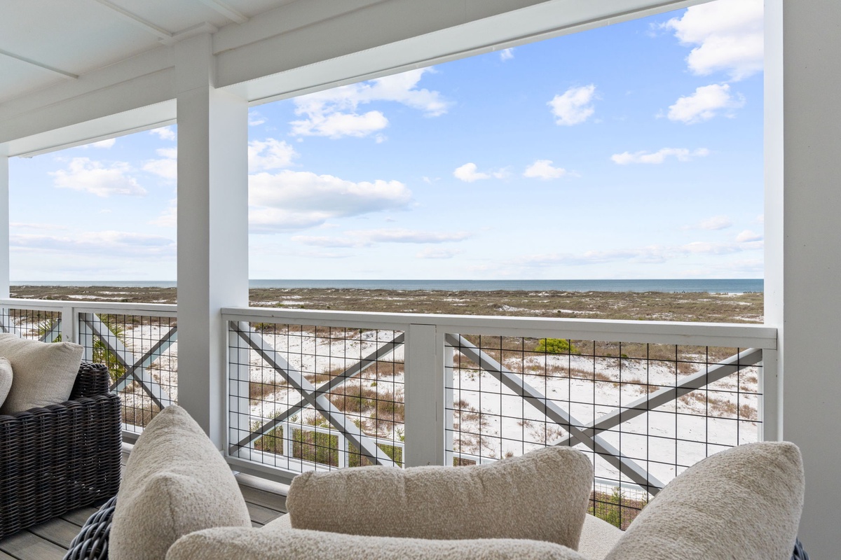 Sink into plush seating while endless ocean views stretch before you through floor-to-ceiling windows on your private balcony.