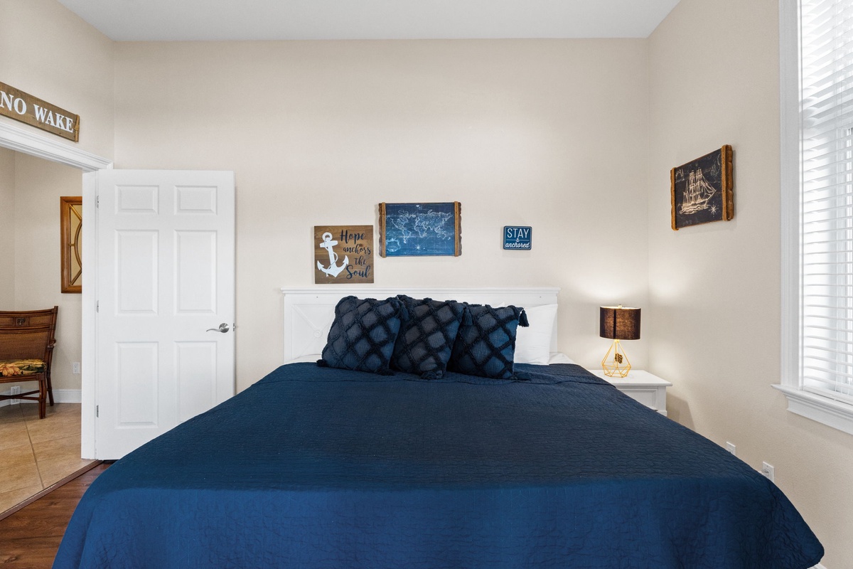 Wake up refreshed in your cozy nautical-themed bedroom, complete with plush navy bedding and charming coastal decor that makes every morning feel peaceful.