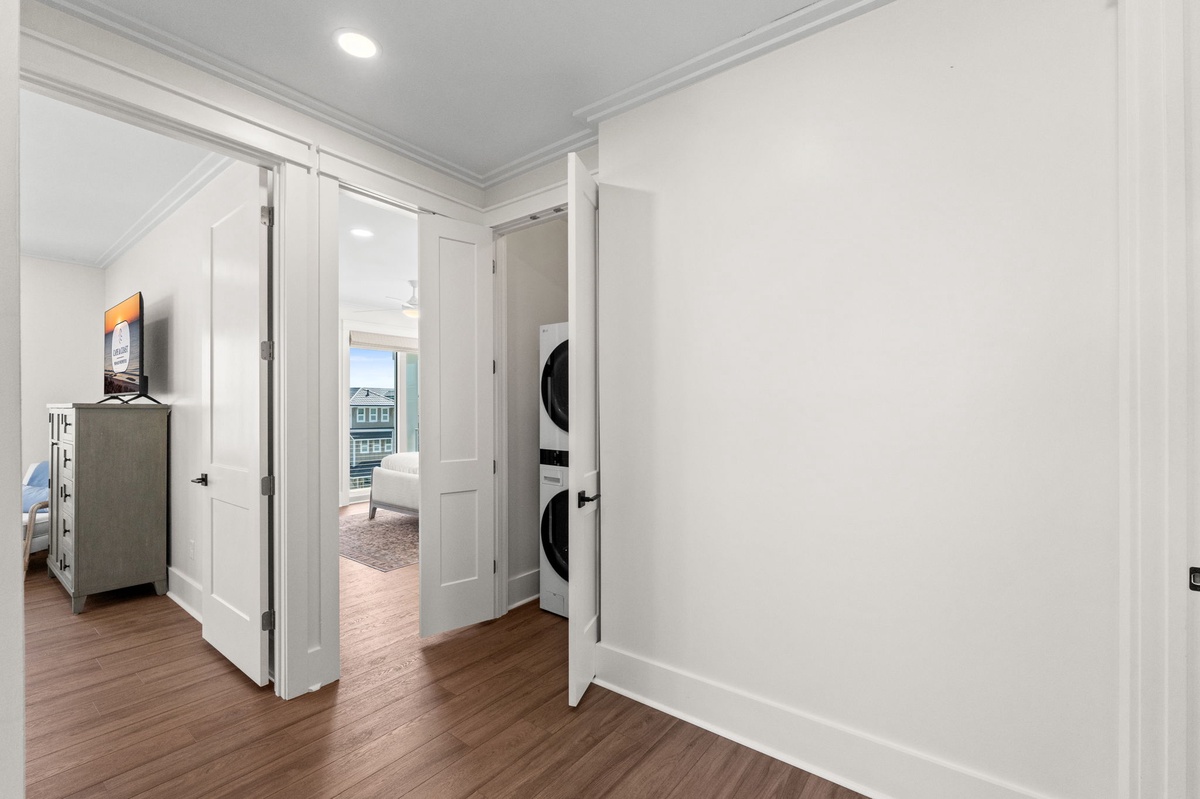 A thoughtfully designed hallway connects your living spaces with practical touches like in-unit laundry—making your stay as convenient as it is comfortable.
