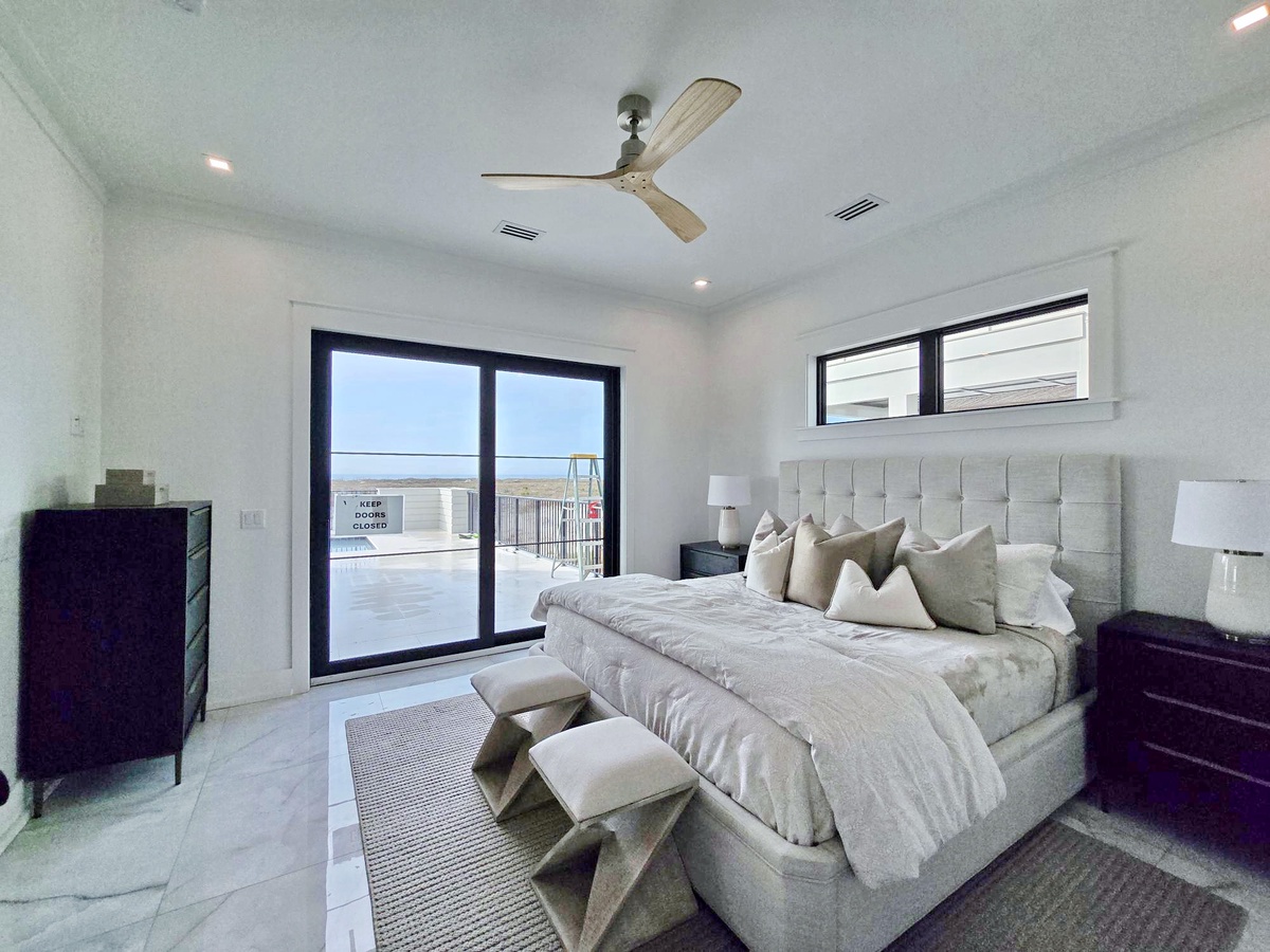 Rest peacefully in this serene bedroom where soft linens and gentle ceiling fan breezes create your perfect sleep sanctuary.