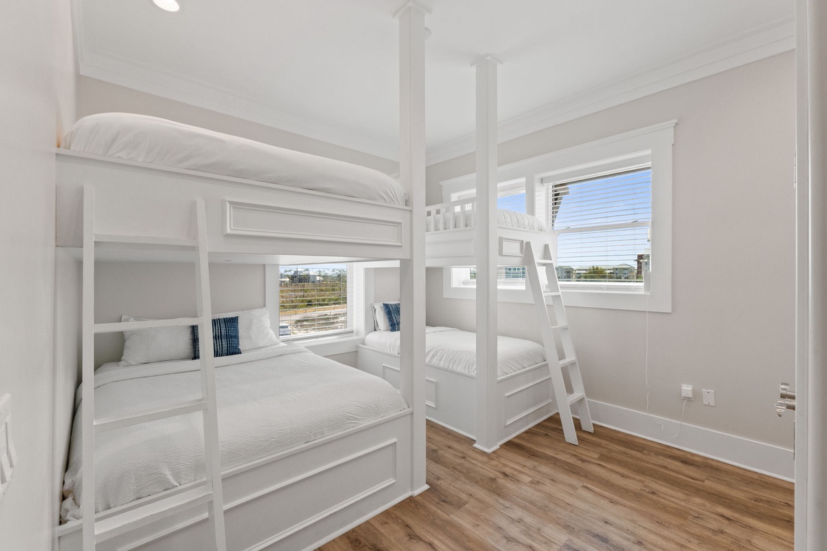 Your kids will love these custom white bunk beds with built-in storage and cozy reading nooks by sunny windows.