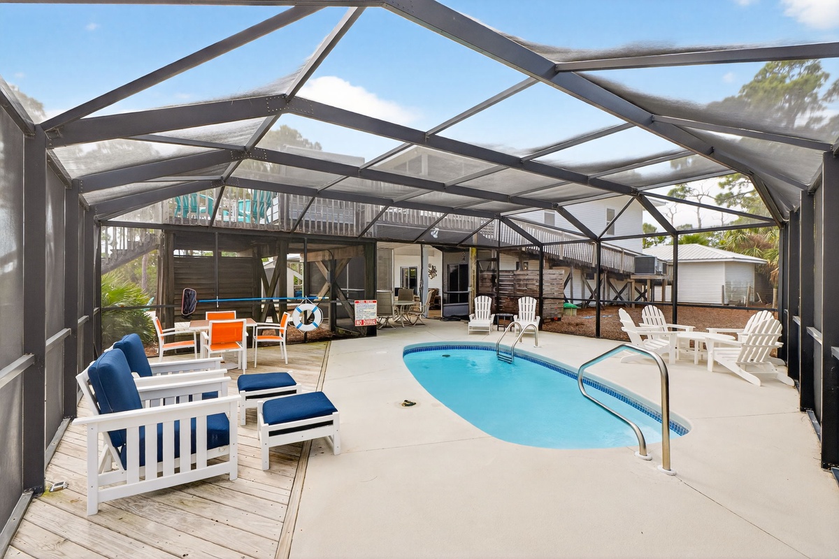 Your private screened pool area awaits with comfortable seating and crystal-clear water for refreshing dips anytime.