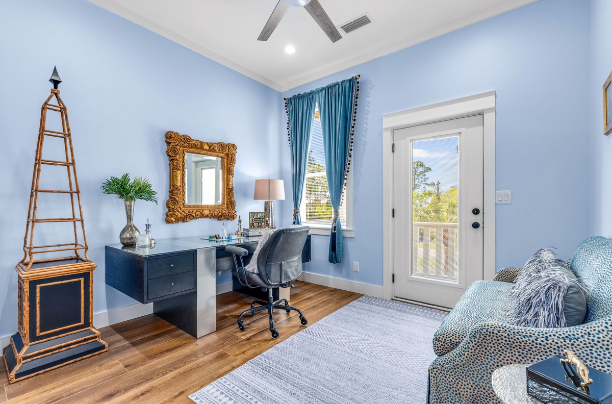 Your serene home office with elegant blue tones, floating desk, and French door balcony access creates the perfect work-from-vacation space.