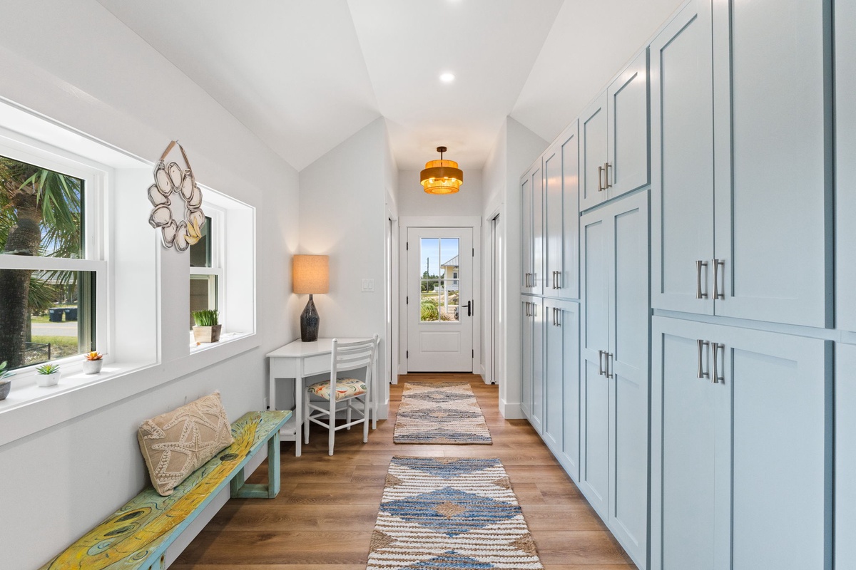 Step into your home away from home through this bright, welcoming entryway with coastal-inspired touches, plenty of storage, and natural light that sets the tone for your stay.