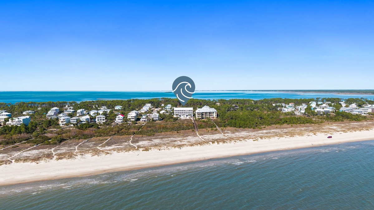 Stunning beachfront location with pristine sandy shores and crystal-clear waters stretching to the horizon.