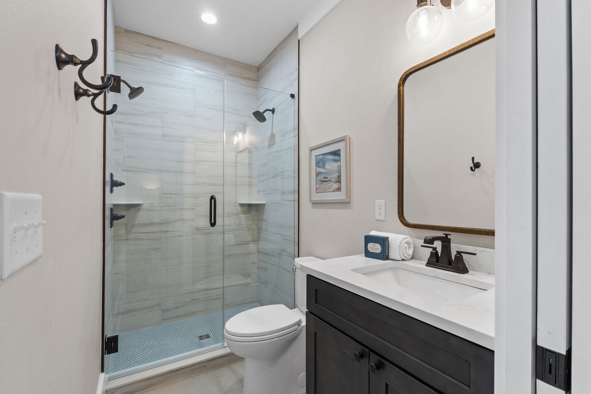 Step into your private spa-style retreat with stylish modern fixtures, a spacious walk-in shower, and thoughtful coastal touches that make every refresh feel like a getaway.