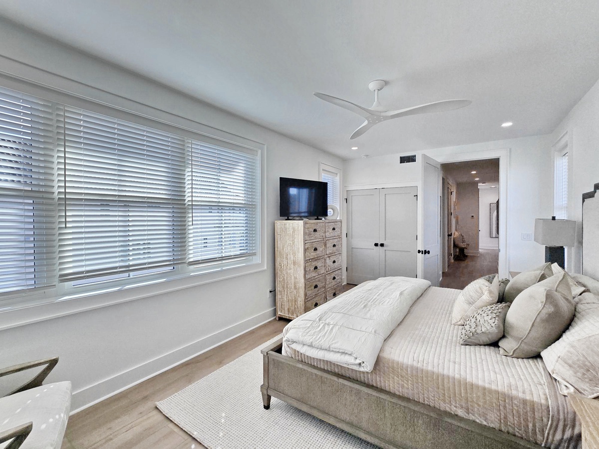 Drift off in this serene bedroom where soft linens meet coastal elegance. You'll love the natural light and peaceful atmosphere.