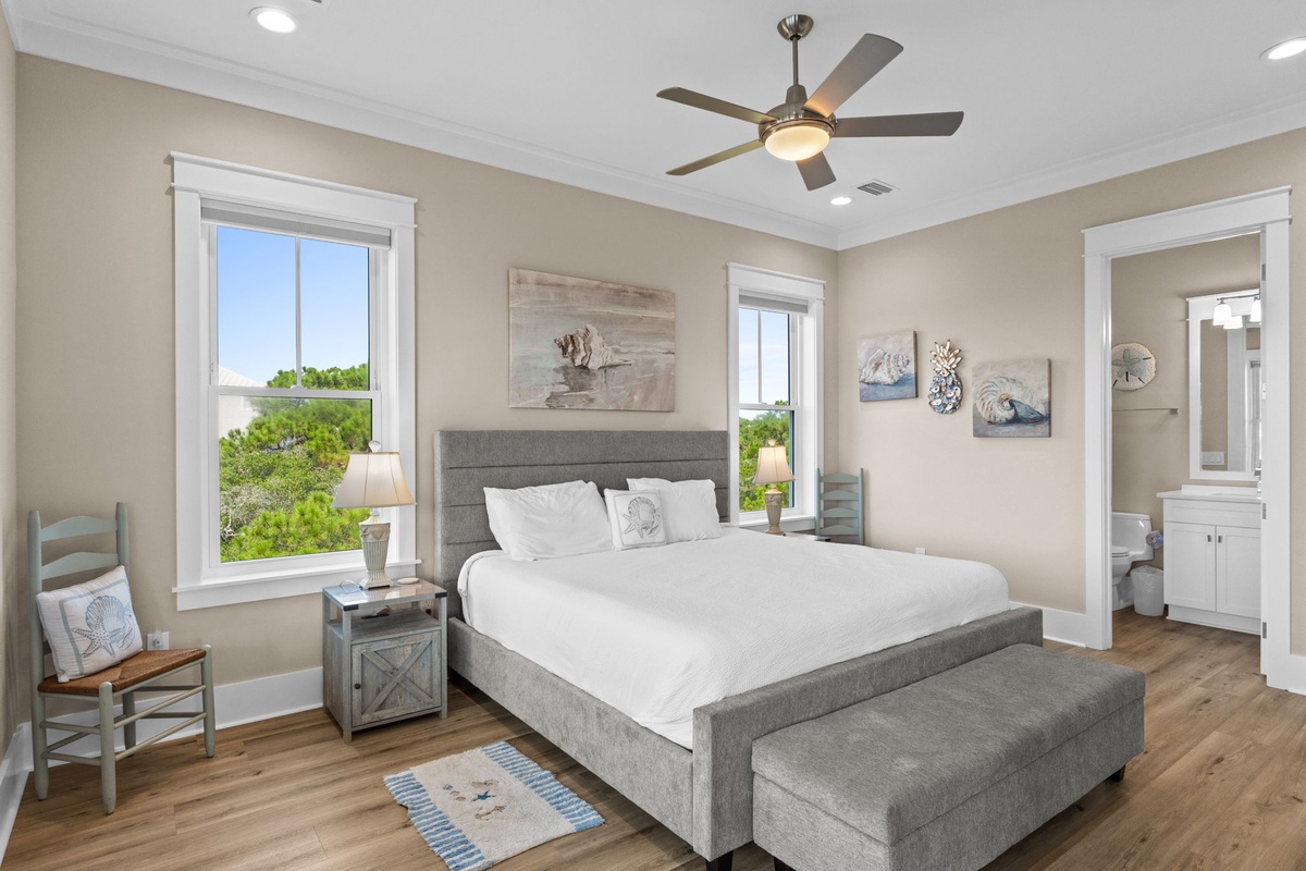 Wake up to gentle breezes and natural light streaming through your windows as you enjoy views of lush greenery. The plush bed and coastal décor create your personal sanctuary.