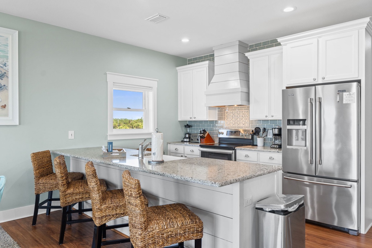 Your fully-equipped kitchen invites you to whip up your favorite meals, with gleaming granite countertops, stainless-steel appliances, and a bright island perfect for casual dining or morning coffee together.