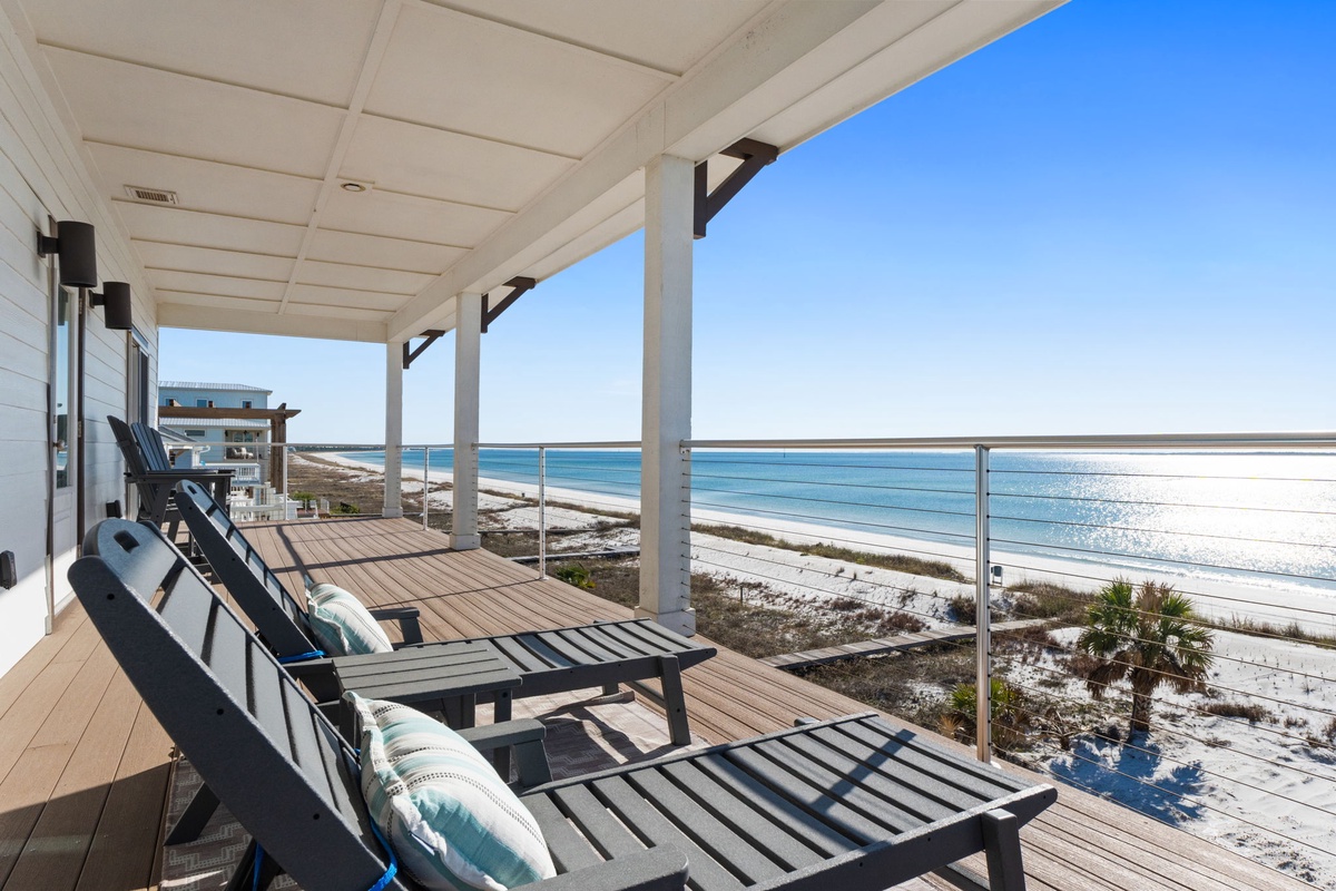 Relax on your private deck with stunning ocean views, where you can lounge in comfort while watching waves roll onto the pristine beach below.