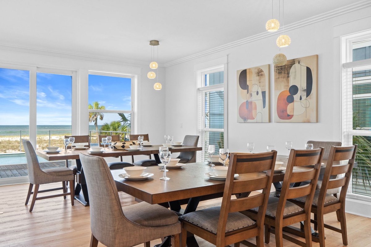 Gather around your spacious dining table with beach views right outside. Elegant lighting, coastal artwork, and seating for everyone set the scene for memorable meals together.