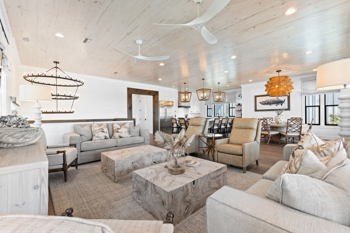 Sink into plush seating in your bright, airy living space with stunning coastal details and soaring wood-plank ceilings.