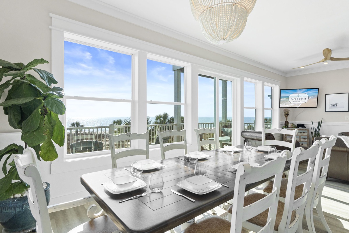 Gather around your elegant dining table as ocean breezes flow through the bright windows, creating the perfect atmosphere for memorable meals together.