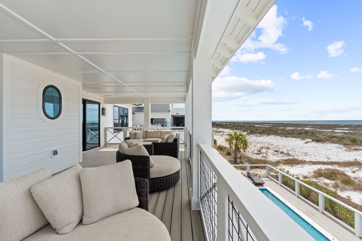 Unwind on your private balcony with plush seating and sweeping views of pristine coastal landscape stretching to the horizon.