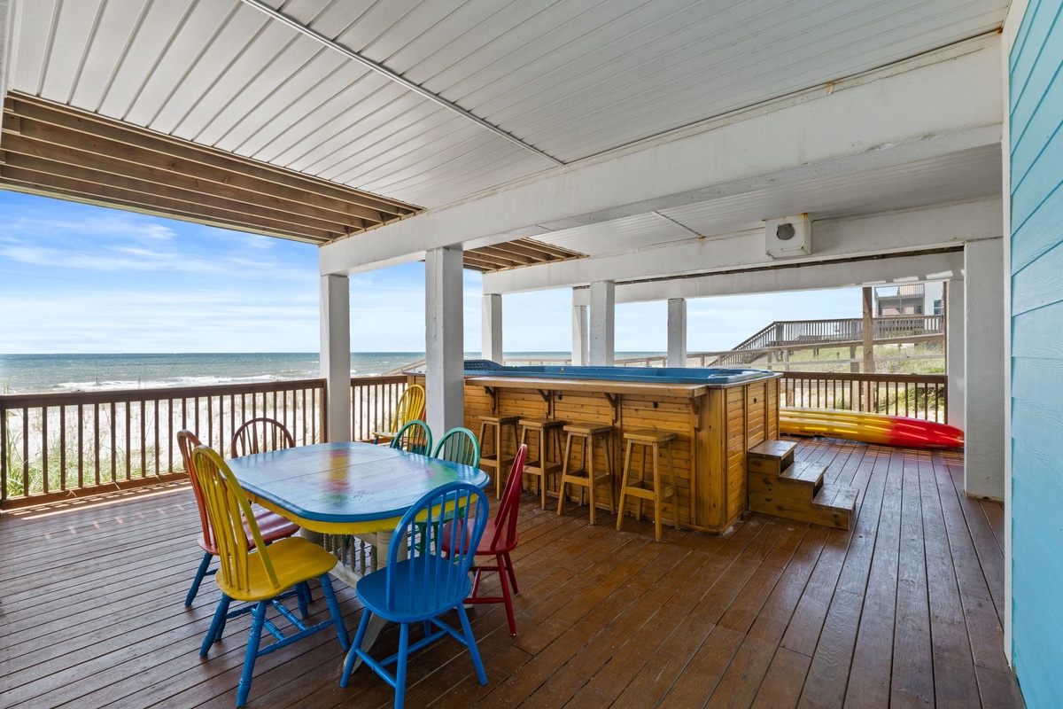 Sip your morning coffee at this beachfront deck, where colorful seating and a tiki bar frame stunning ocean views just steps from the sand.