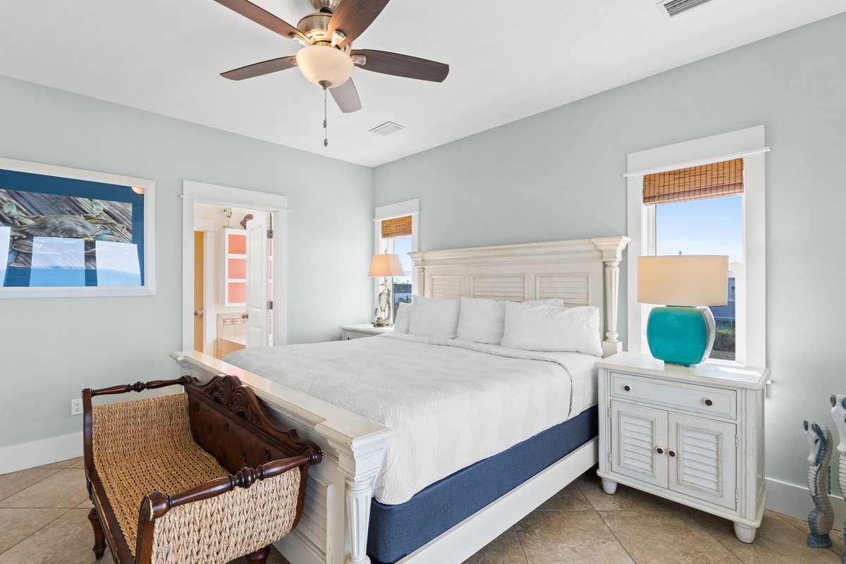 Rest peacefully in your coastal bedroom with crisp white linens and ocean-inspired blues framing stunning water views.