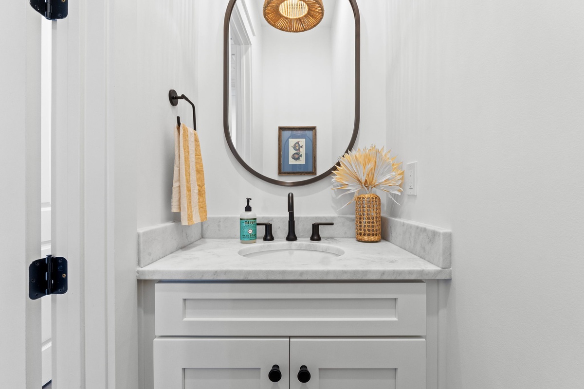 Your stylish powder room features marble countertops, modern fixtures, and thoughtful touches that make freshening up feel luxurious.