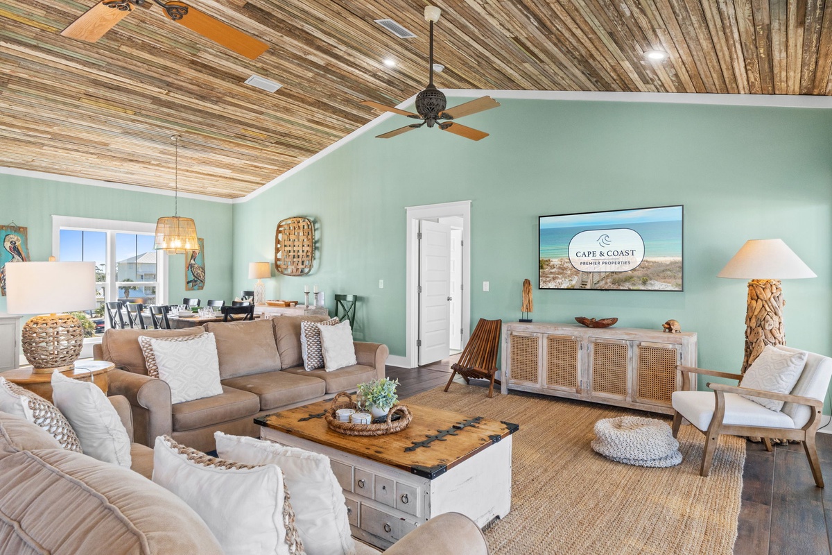 Unwind in your coastal-inspired living room where warm wood ceilings and soft mint walls create the perfect beach house retreat.