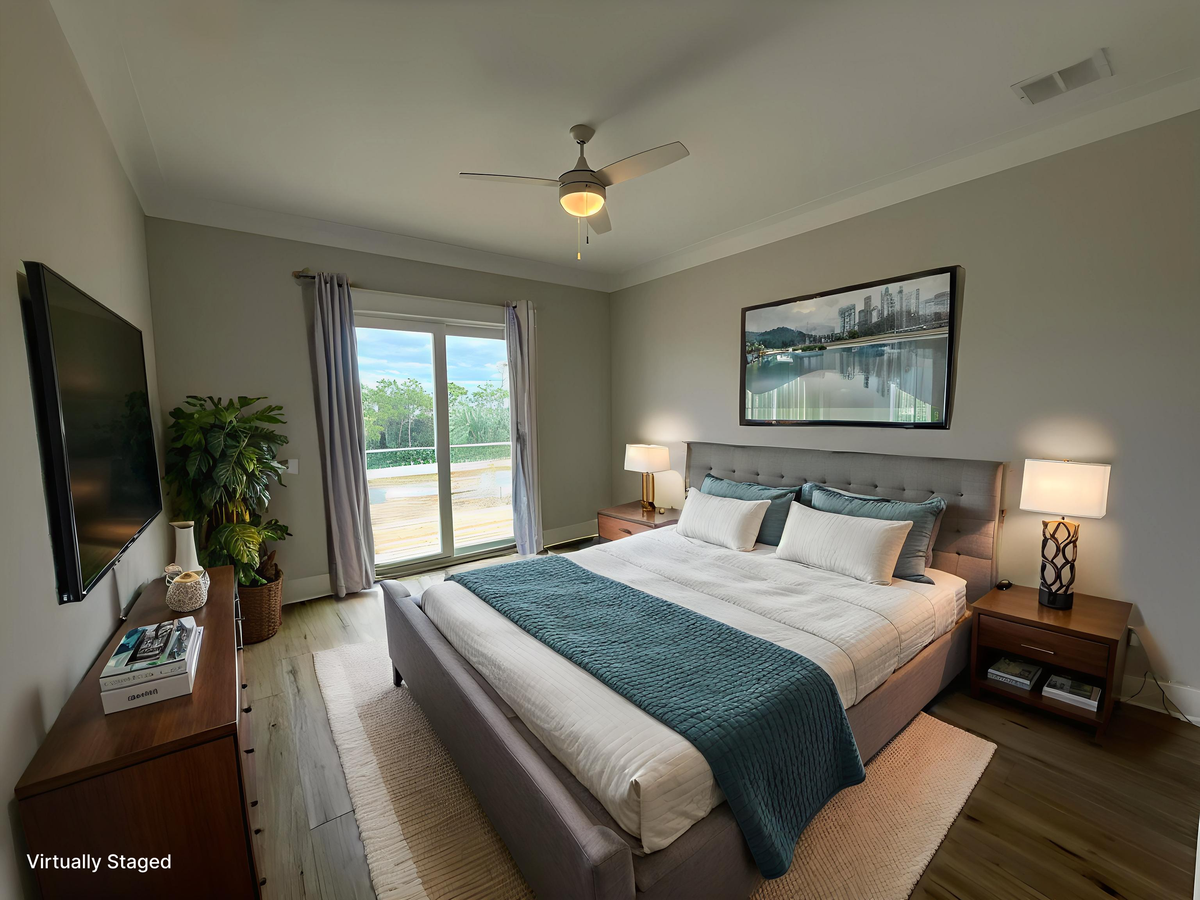 Sink into crisp white linens and soothing blue accents in your peaceful bedroom retreat, complete with modern amenities and serene natural light.