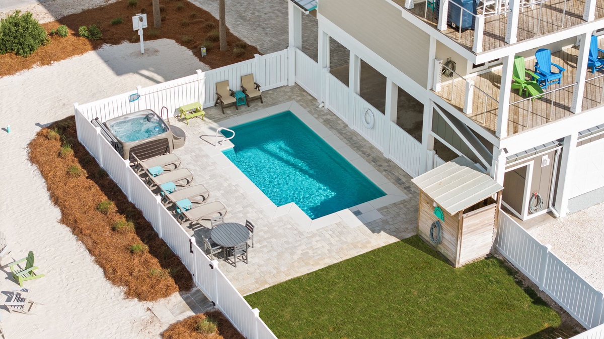 Aerial view of the vacation rental showing a private swimming pool, hot tub, and multiple deck levels with outdoor seating areas.